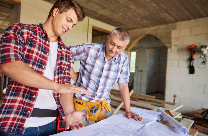 contractor reviewing home rebuilding plans to avoid being underinsured