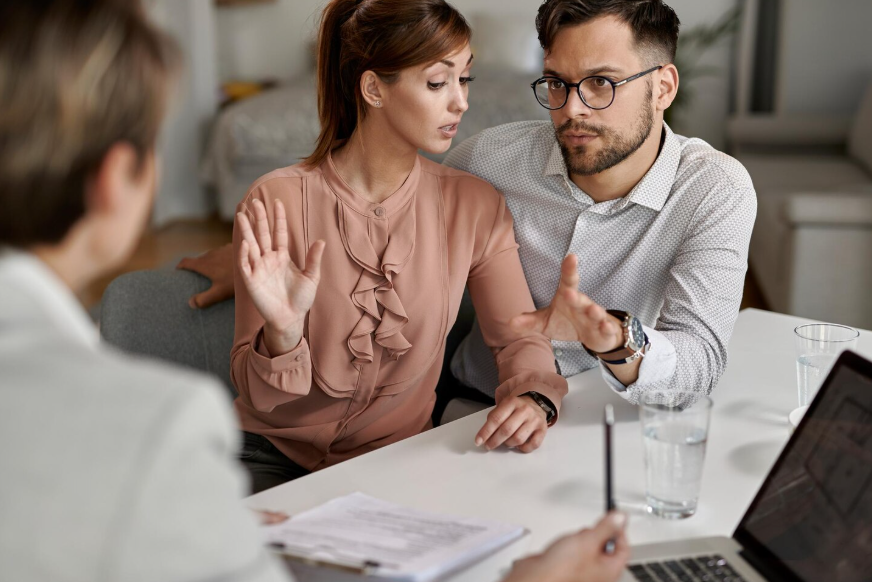 Couple discussing insurance coverage to avoid insurance mistakes first time buyers make