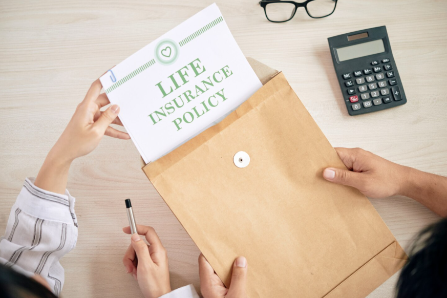 Person reviewing life insurance policy documents to identify insurance policy red flags