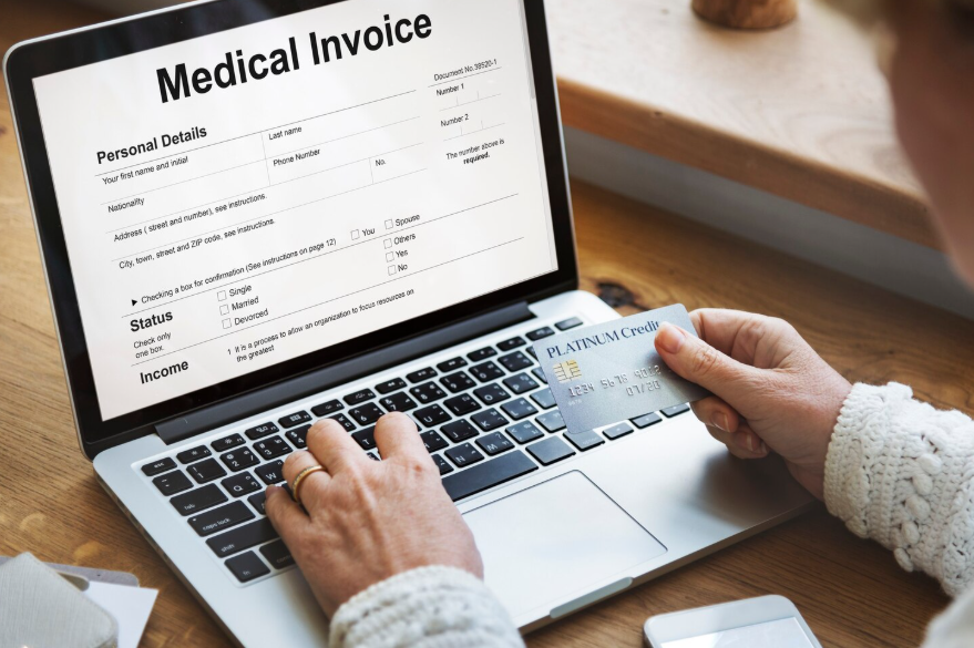 Patient reviewing medical invoice on laptop showing out-of-network costs