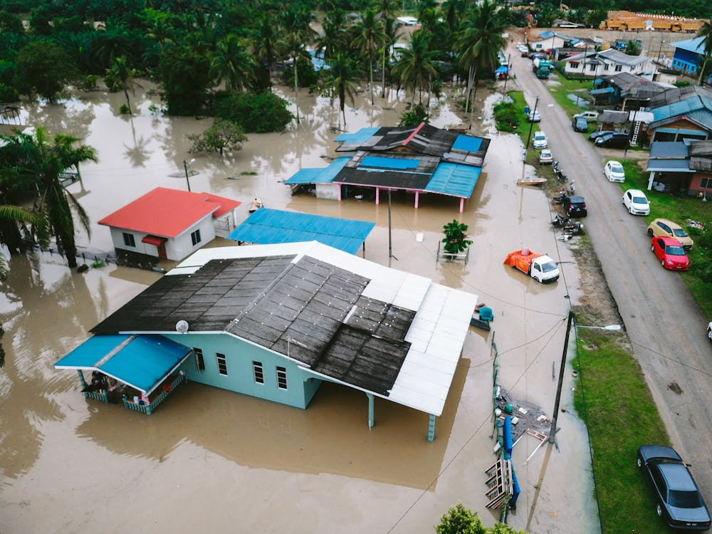 Flooded neighborhood showing why homeowners insurance does not cover floods